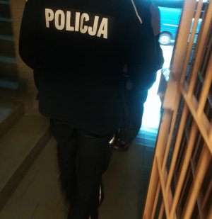 policjant przy kratach aresztu