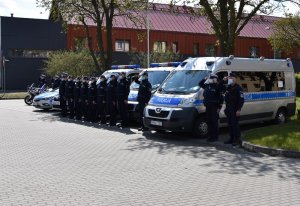 na placu obok budynku lęborskiej komendy policji, ustawieni w szeregu przy oznakowanych radiowozach i motocyklach policyjnych umundurowani policjanci, salutując, oddają hołd zmarłemu koledze