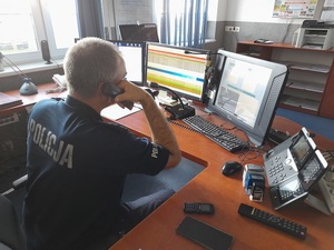 dyżurny policji na stanowisku kierowania rozmawia przez telefon