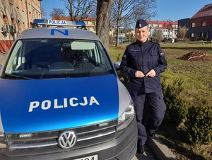 policjantka stojąca przy radiowozie