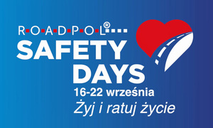 niebieska plansza z czerwono - białym sercem, przez które przebiega droga i napis o treści &quot;roadpol safety days 16-22 września żyj i ratuj życie&quot;