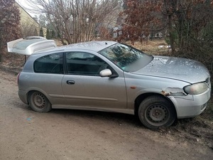 szary nissan almera unieruchomiony przy niewielkiej skarpie