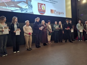 w kinie przed ekranem stoją uczniowie - uczestnicy festiwalu oraz jurorki, w tym policjantka. Jedna z jurorek przemawia przez mikrofon